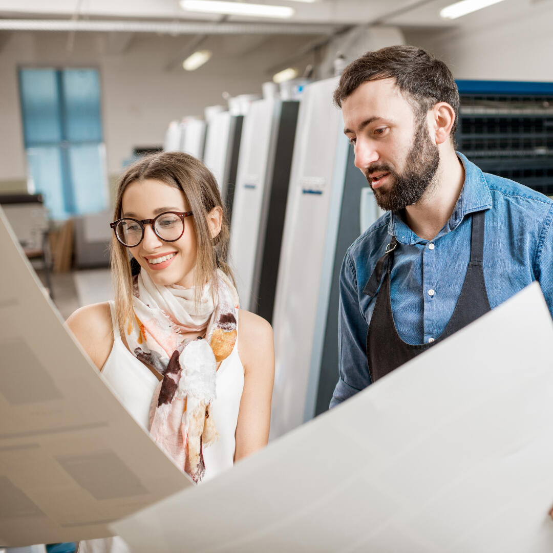 Exhibitpath on demand printing team looking at paper